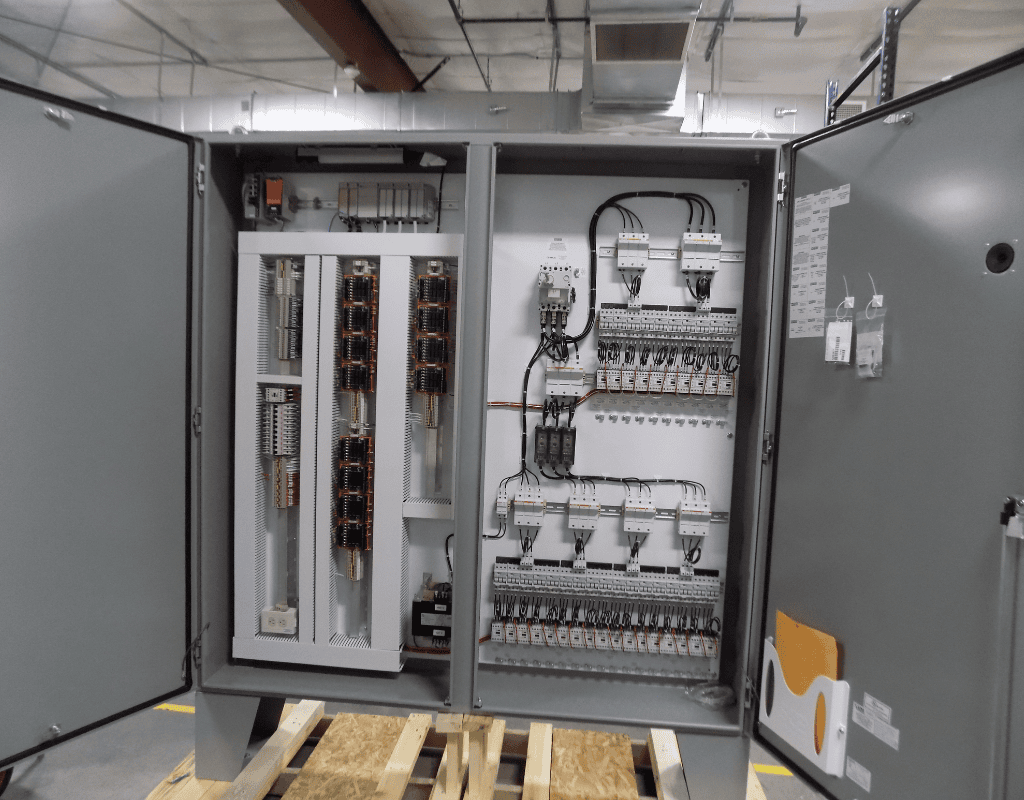 Open industrial control cabinet showing wiring and relays for system upgrades in a Southern New England refrigeration installation.